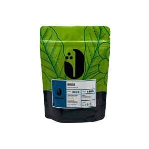 JAMAI CAFE Brazílie Santos 17/18, zrnková káva 100 procent Arabica, stojací sáček s listovým motivem a přední etiketou.